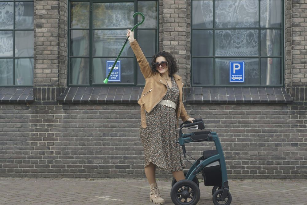 Woman walking confidently with a rollator walker