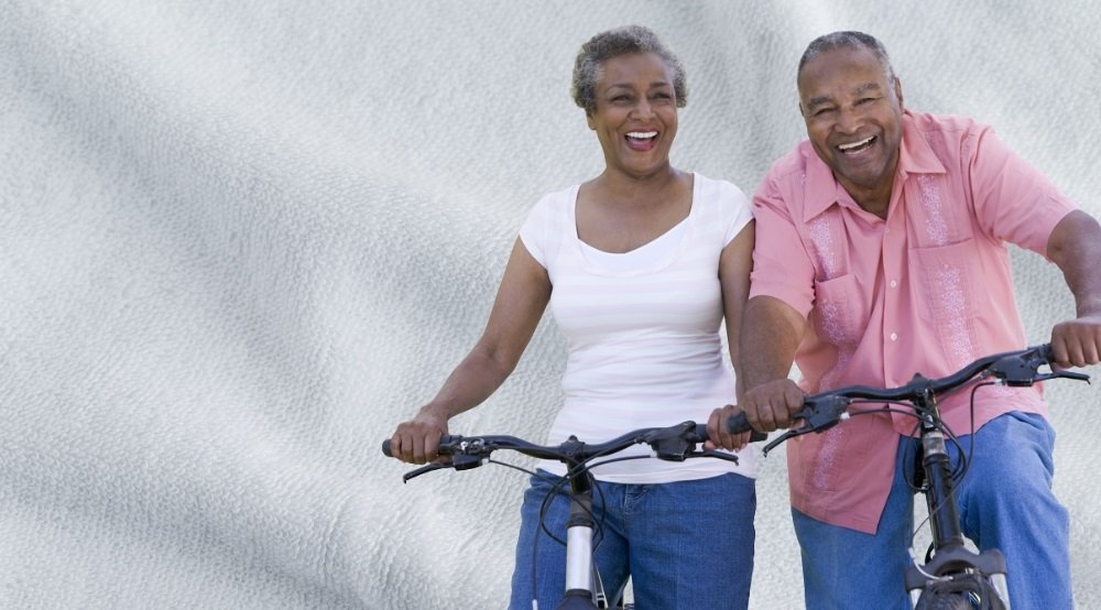 Happy senior couple riding bicycles